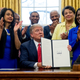 President Donald Trump holds up the Historically Black Colleges and Universities HBCU Executive Order after signing it, on Feb. 28, 2017, in the Oval Office.
